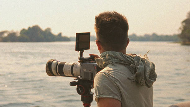istock Photographer with Professional Camera Captures Scenic River Landscape 2233263228