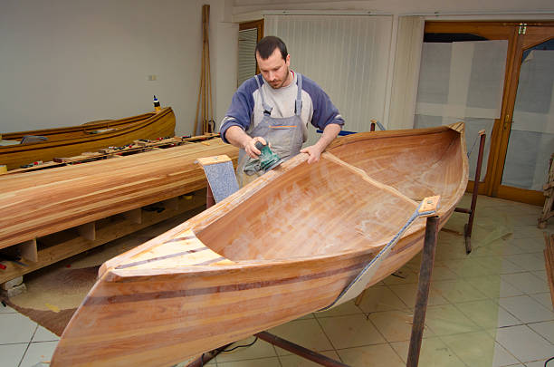 istock Carpenter making canoe of his own design 2233263776