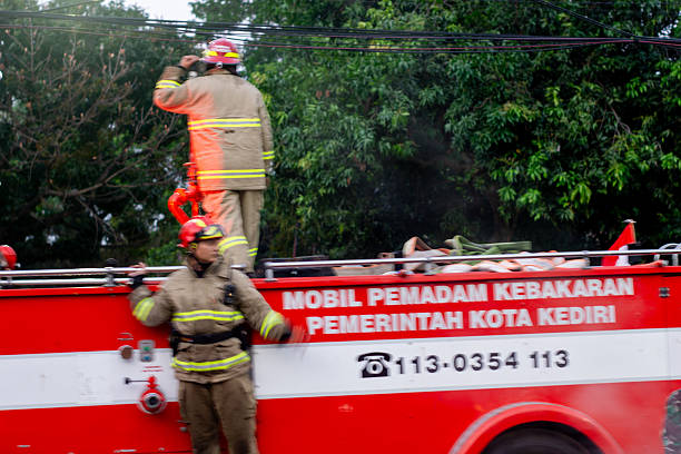 Kediri, East Java, Indonesia - August 30, 2025 : An Indonesian firefighter is carrying out his duties professionally.