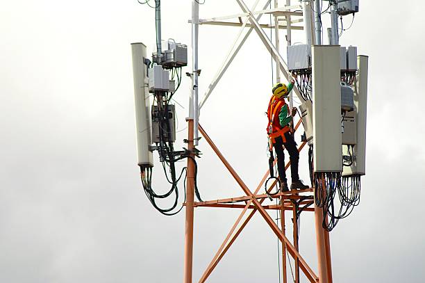 istock Telecom technician performing maintenance on antenna tower in Brazil 2233270130