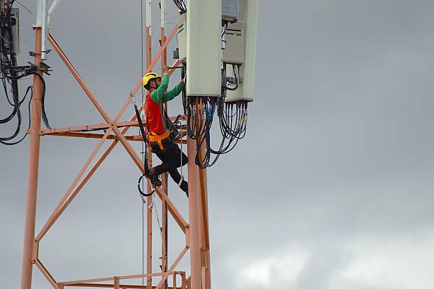 istock Telecom technician climbing tower and inspecting antenna cables in Brazil 2233270207