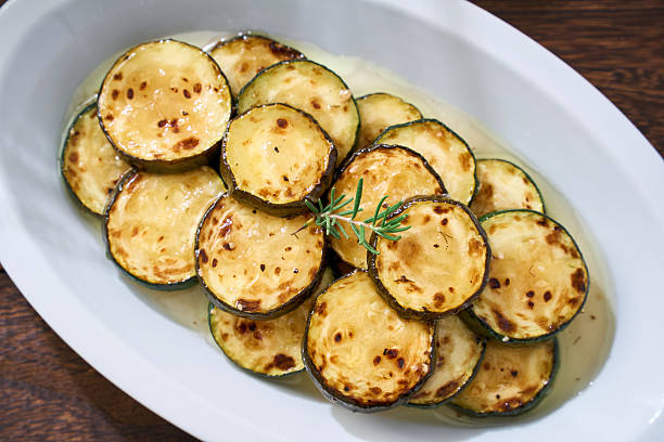 istock Grilled Marinated Zucchini Slices on White Plate 2233272572