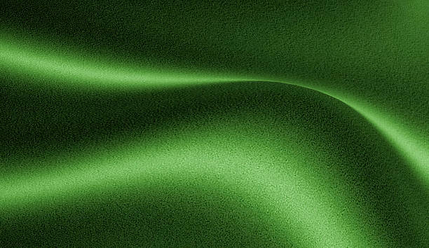 istock An abstract image with a grainy green surface. A curved line of light crosses the middle, giving a feeling of smooth and calm movement. 2233276086