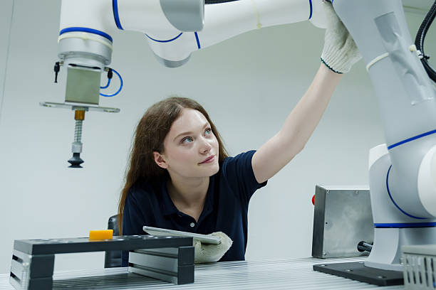 istock young female trainee adjusts robotic arm position during hands on robotics training class highlighting control technique and safety in industry 4.0 smart factory development 2233277859