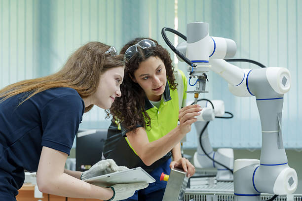 istock two female engineers operate robotic automation machine with collaboration during training session in smart factory environment using glove and tablet for machine control 2233277875