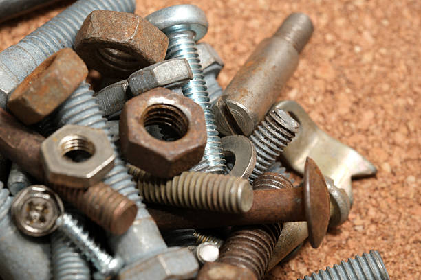 istock Diverse collection of screws and bolts scattered on a workbench 2233278111