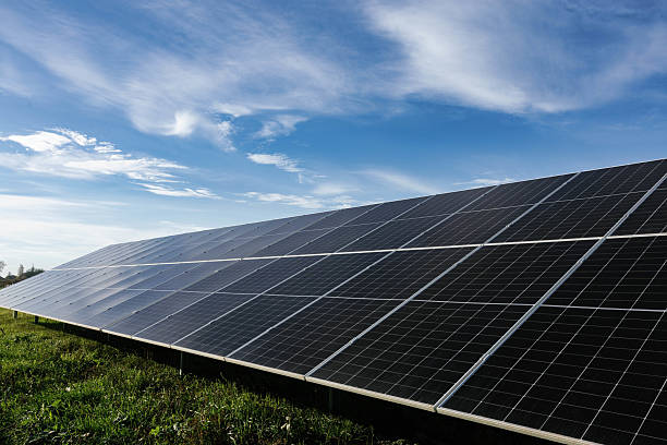 istock Solar panels absorbing sunlight under a cloudy blue sky 2233281864