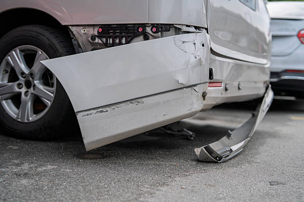 Car accident close-up. The car crashed into a concrete road fence on a suburban dirt road. Dangerous driving
