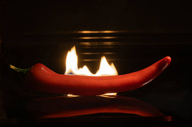 Red hot chilli pepper against the background of a burning flame.