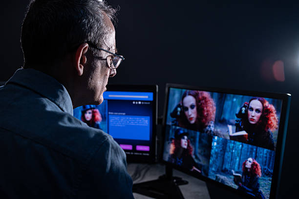 Male IT engineer doing maintenance on artificial intelligence systems. Senior male website designer, generates an image with artificial intelligence (AI) and creates a prompt