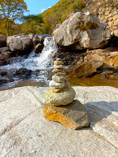 Stone balance on the background of a waterfall