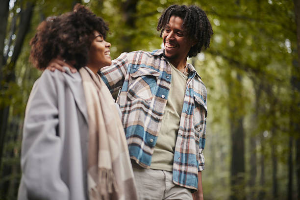 istock Happy black couple walking during the day at forest. 2233285898