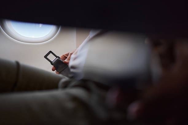 istock Fastening seatbelt in a plane! 2233286619