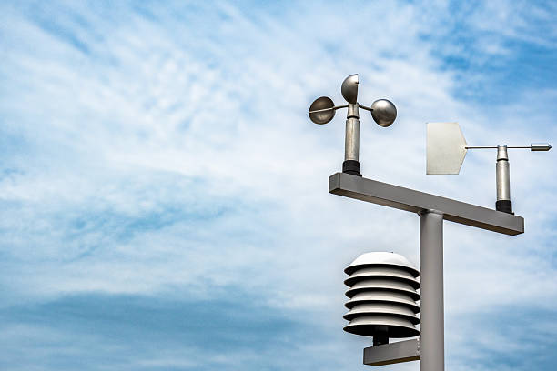 A weather station stands against a backdrop of a cloudy sky, showcasing its meteorological instruments