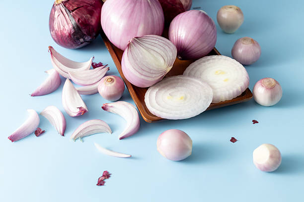 istock Fresh and Colorful Onions on Blue Background with Slices and Whole 2233287499