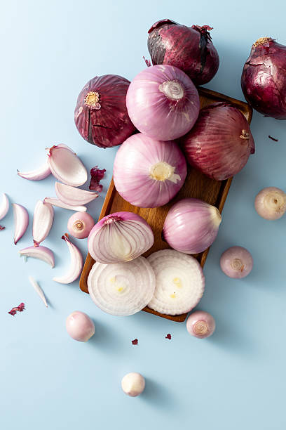 istock Fresh Red and Purple Onions Displayed on Blue Background 2233287513