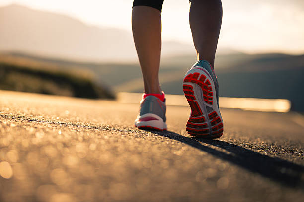istock Woman runner running in sunset mountain road 2233288737