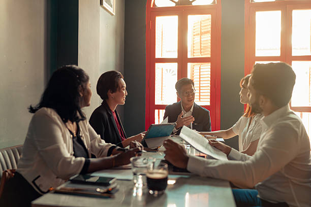 istock Diverse and multiracial Asian team working during business lunch 2233291019