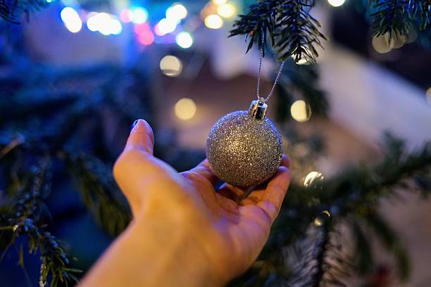 istock Decorative Silver Ornament Hangs from Christmas Tree Branch New Year holiday festive atmosphere preparation 2233291096