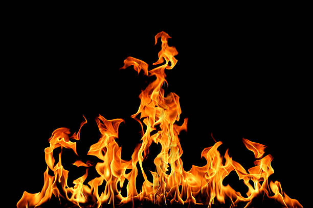 istock orange fire flames isolated on a black background, abstract burning texture symbolizing heat, energy, danger, and power, perfect for design, advertising, safety concepts, and backgrounds. 2233291635