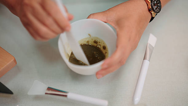 Preparing a centella face mask by mixing it in a bowl for a skincare routine