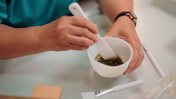 istock Preparing a centella face mask by mixing it in a bowl for a skincare routine 2233292320
