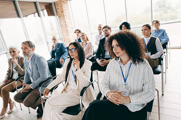 istock Diverse group of professionals attending a corporate seminar within a contemporary workspace, focused on teamwork and collaboration 2233293186