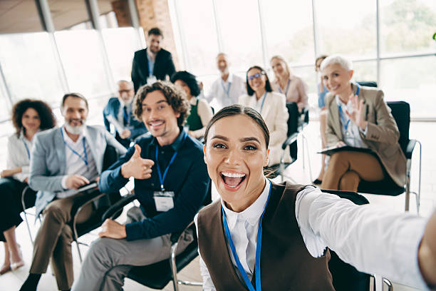 istock Happy professionals during a corporate workshop taking a cheerful group selfie showcasing teamwork and office camaraderie 2233293236