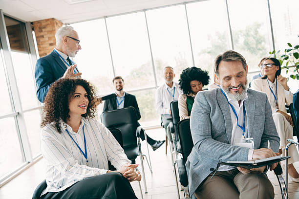 istock Professional group discussion with diverse businesspeople at a team workshop activity in a bright modern office 2233293254