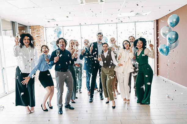 istock Team Celebrating in an Office with Confetti and Toasts Representing Collaboration and Diversity in the Workplace 2233293336