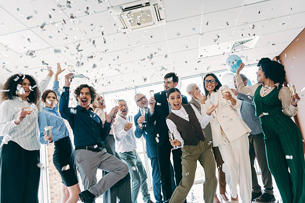 istock Diverse group of professionals celebrating in an office environment with confetti and champagne, showcasing teamwork 2233293337