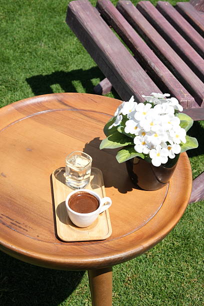 Coffee cup and orchid flower on table at balcony