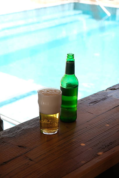 istock Refreshing beer by the pool on a summer day 2233296412