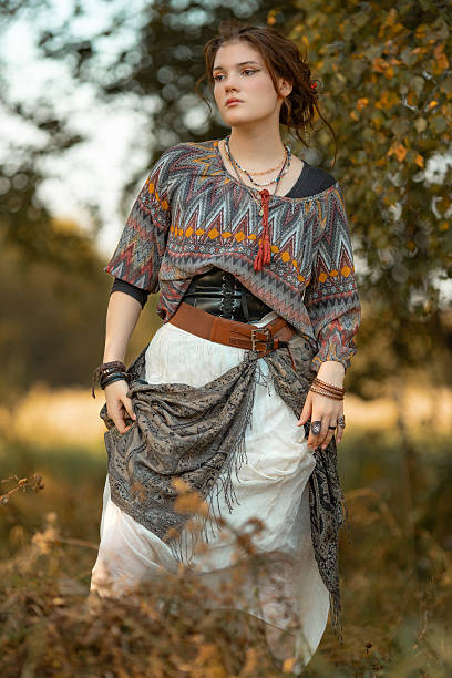 istock Young woman in boho style clothes posing in autumn forest 2233298951
