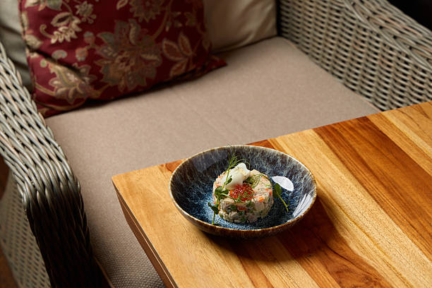 A handcrafted, artisanal sushi dish is elegantly served in a cozy and inviting ambiance