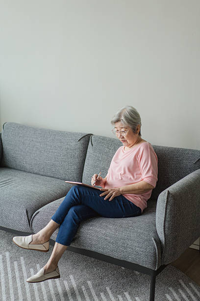 istock Active ageing - Asian chinese senior woman using a tablet 2233301594
