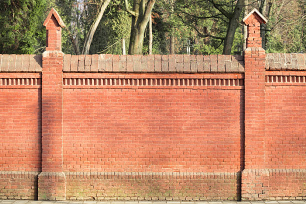 brick fence outskirts abandoned building site red building material construction with background blurred nature view