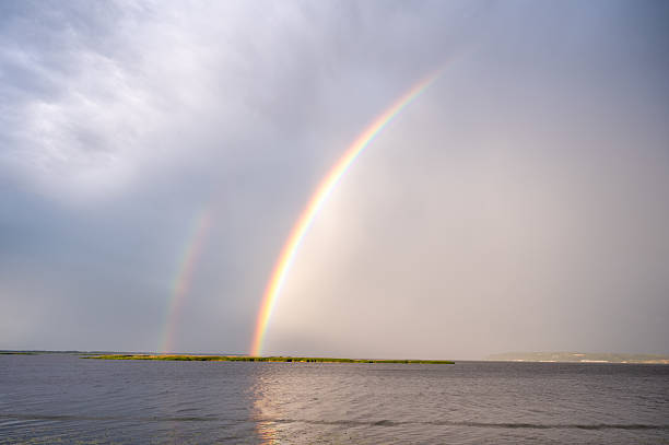 istock A beautiful sunset over the river with a double rainbow 2233303096