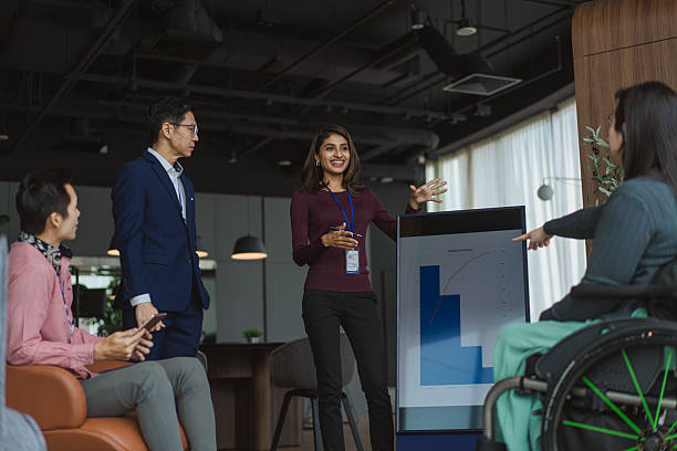 istock Diverse Asian business team including a co worker with disability staying engaged during a breakout strategy discussion 2233303502