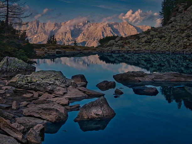 Scenic mountain autumn/fall landscape with mountain lake, rocks, cliffs, trees, water surface during autumn. Mystique  relaxing  nature. Spiegelsee/Reiteralm/Schladming-Dachstein resort, Austria.