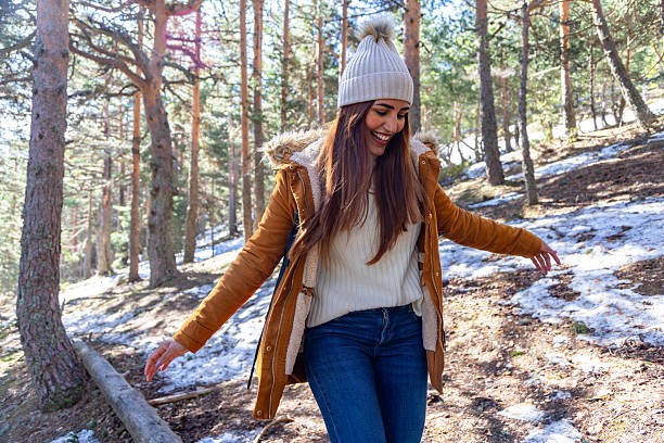 istock Young woman balancing while hiking in snowy winter forest 2233305936