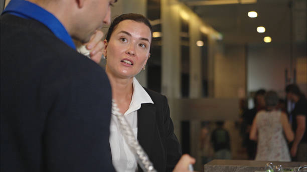 istock A hotel receptionist assisting with check-in and check-out 2233306588