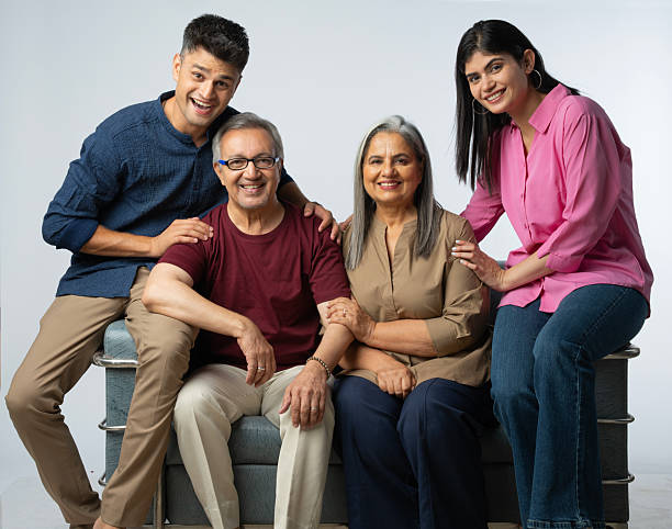 istock Two generation family sitting on sofa against white background 2233306974