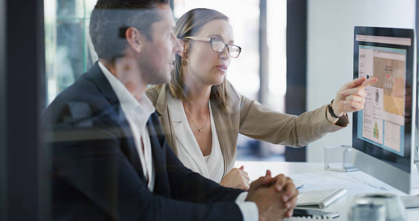 istock Team, computer screen and business people in office for planning, budget chart or brainstorming. Meeting, discussion and pointing at monitor with advisor for stats, financial review or proposal 2233307045
