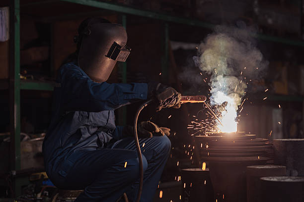 istock Industrial worker with safety equipment operating a welding procedure 2233307759