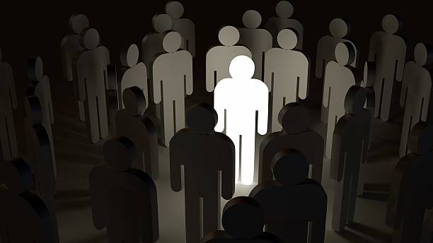 istock A crowd of abstract human figures and the central figure is glowing. 2233308501