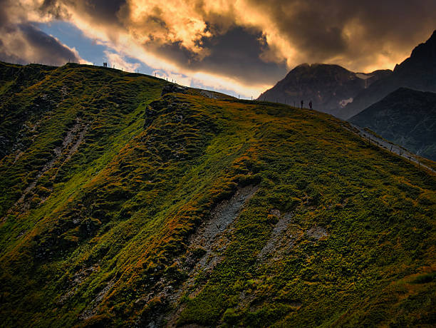 Scenic fantasy landscape with rocks, cliffs and high mountains, dramatic sky, Creative post processing.. Based on landscape near Saalbach - Austrian Alps .