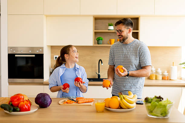 istock Father and daughter share joyful moments while preparing a healthy meal together 2233309010
