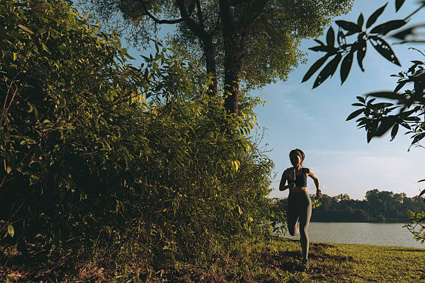 istock Female Chinese running along a forest nature trail 2233310378