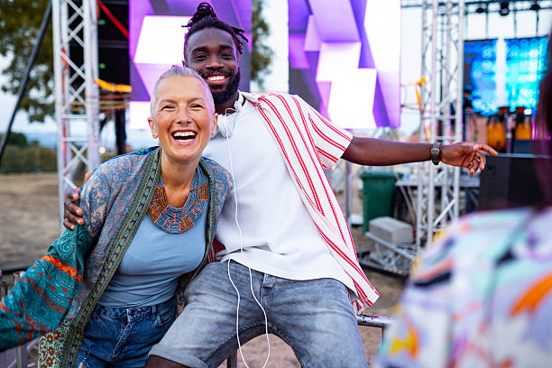 istock Large group of cheerful people having fun while dancing on music concert 2233310383